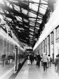 People walking on railroad station platform