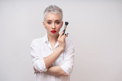 Portrait of a beautiful young woman over white background
