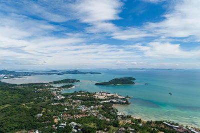 High angle view of sea and townscape against sky