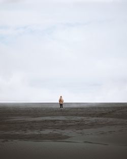 Man on beach against sky