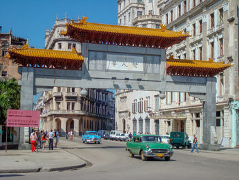 Vehicles on road amidst buildings in city