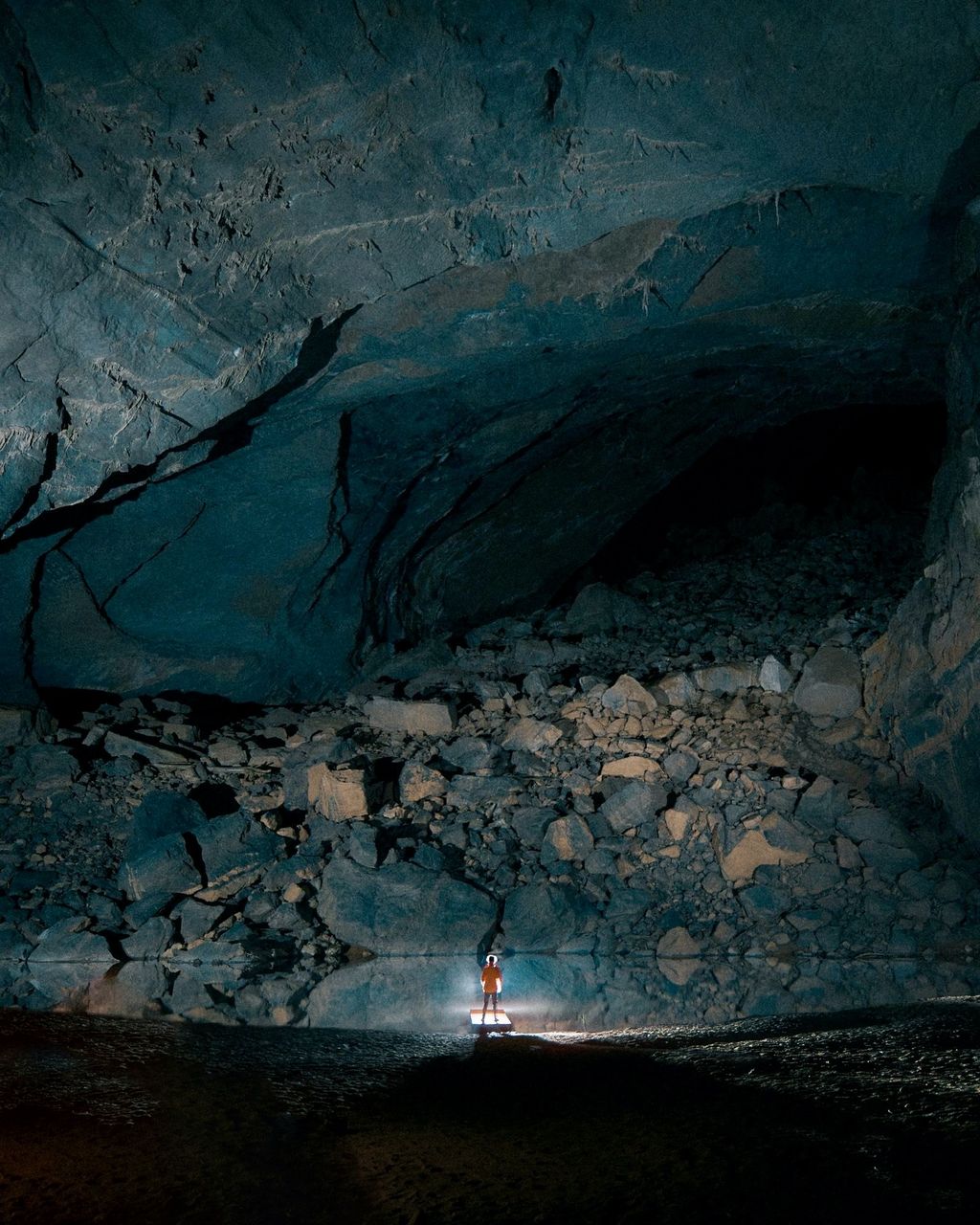 cave, nature, formation, darkness, water, beauty in nature, one person, rock, land, outdoors, ice cave, environment, non-urban scene, scenics - nature, adventure, night, travel, adult, tranquility, landscape, leisure activity, travel destinations, men