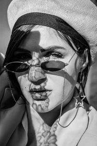 Close-up portrait of young woman wearing hat