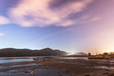 Scenic view of beach against sky at night