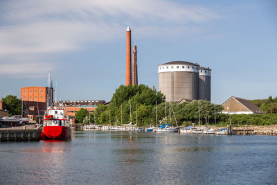 Scenic view of river by building against sky