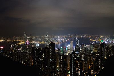 Illuminated cityscape against sky at night