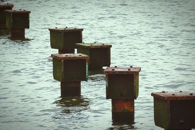 View of wooden posts in water