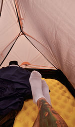 Low section of person relaxing at tent
