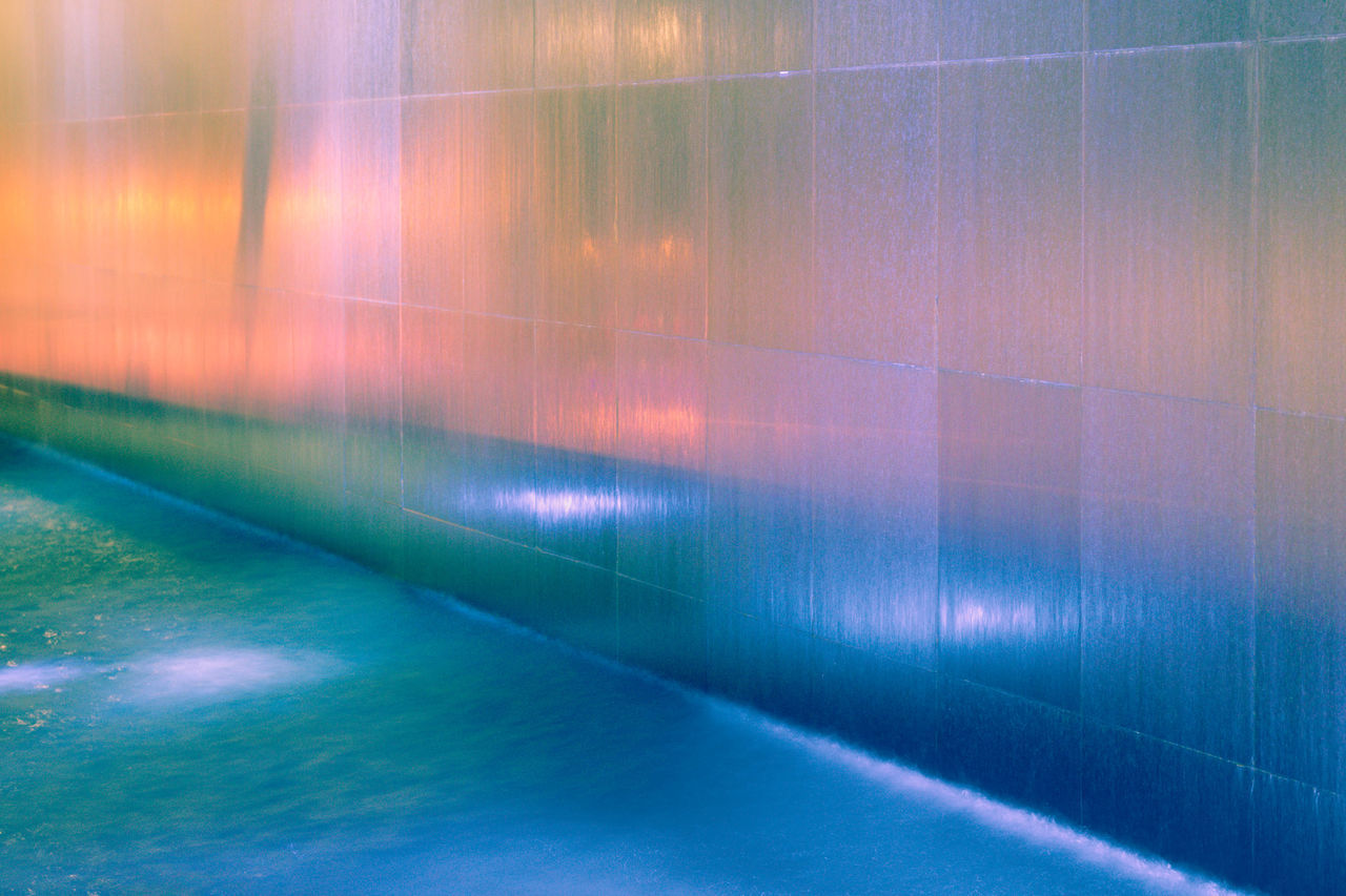 FULL FRAME SHOT OF MULTI COLORED WALL WITH SHADOW