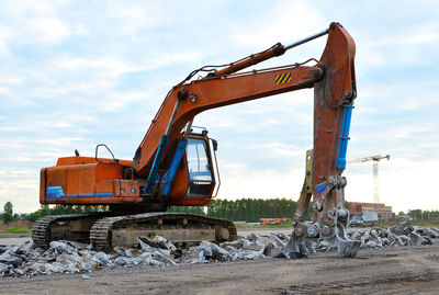 Crane at construction site against sky