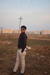 Portrait of man standing against sky