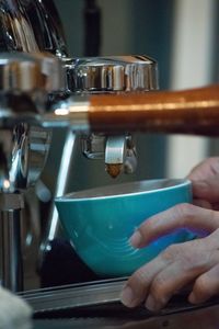 Close-up of hand holding coffee cup