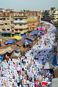 High angle view of people praying on road in city