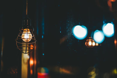 Close-up of illuminated light bulb at night