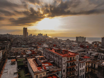 High angle view of buildings against sky during sunset