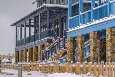 Snow covered buildings against sky