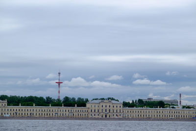 Buildings against cloudy sky