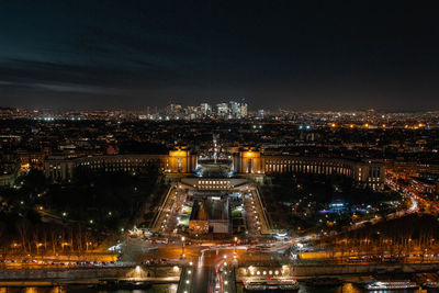 Illuminated cityscape against sky at night