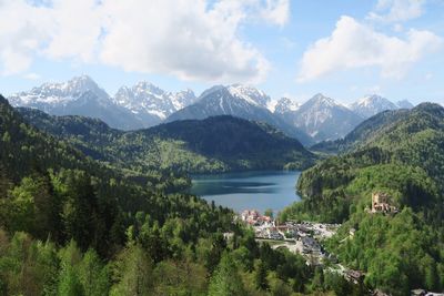 Scenic view of townscape by mountains against sky