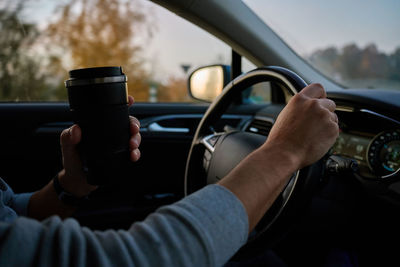 Midsection of man using mobile phone