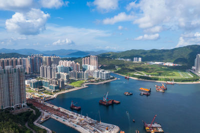 High angle view of bay and cityscape against sky