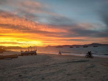 Scenic view of beach against sky during sunset