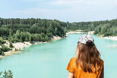 Rear view of woman in sea against sky