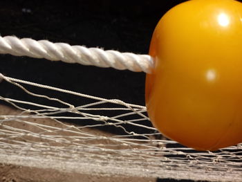 Close-up of orange and rope on table