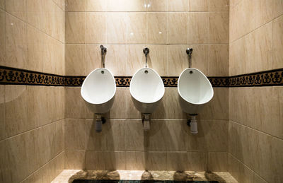 Toilet bowl against wall in bathroom