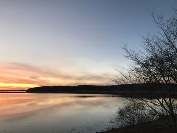 Scenic view of lake against sky during sunset