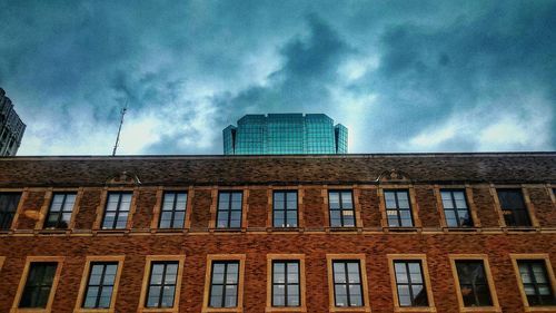 Low angle view of building against cloudy sky