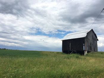 Built structure on field against sky