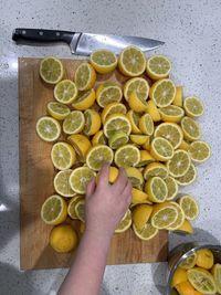 High angle view of hand holding fruit on table