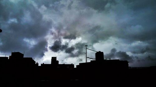 Low angle view of silhouette buildings against sky at dusk