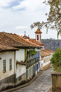 Cobbled street in the city of diamantina with its houses and balconies with the church bell tower