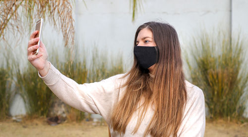 Portrait of beautiful young woman standing outdoors