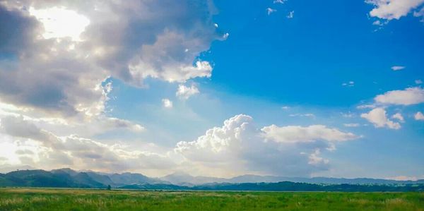 Scenic view of mountains against cloudy sky