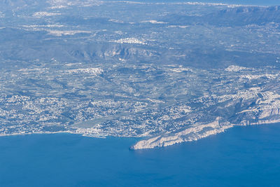 Aerial view of sea and snowcapped mountain