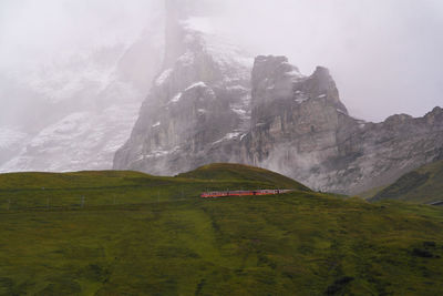 Scenic view of land and mountains against sky