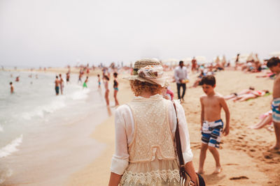 Rear view of woman standing on beach