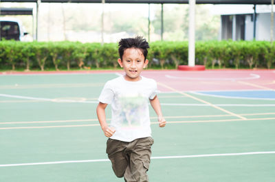 Boy running at basketball court