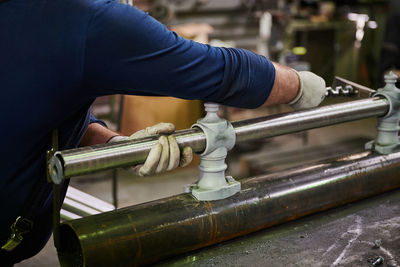 Midsection of man working in water