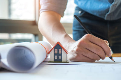 Midsection of man working on table