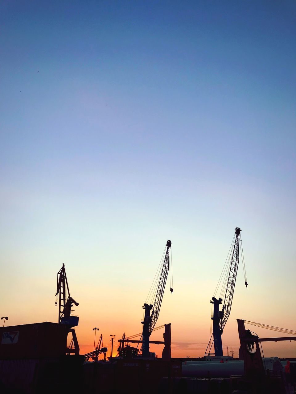 sky, machinery, sunset, crane - construction machinery, industry, clear sky, silhouette, copy space, construction industry, nature, business, freight transportation, development, commercial dock, construction site, crane, architecture, construction equipment, water, no people, outdoors, industrial equipment