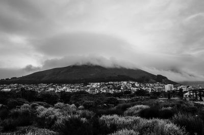 Scenic view of mountain range against cloudy sky