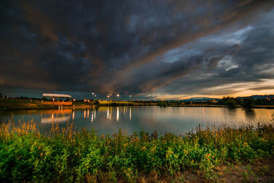 Scenic view of lake against cloudy sky