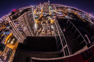 Low angle view of modern buildings against sky at night