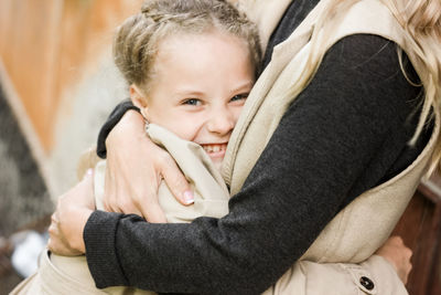 Portrait of cute girl embracing mother