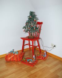 Christmas tree on hardwood floor against wall