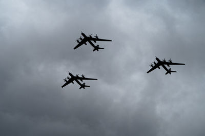 Low angle view of fighter planes flying against sky